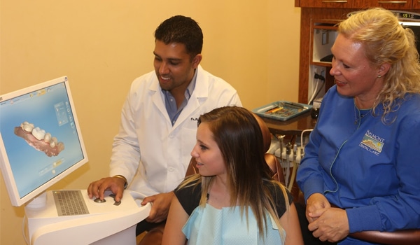 belmont dentistry scottsdale dentist puneet sandhu with his patient