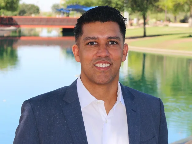 Dr. Puneet Sandhu smiling in a professional portrait