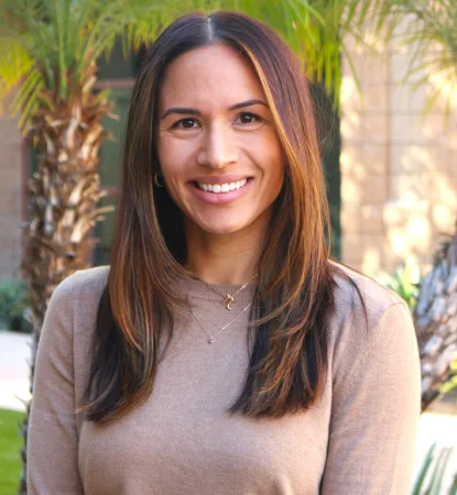 Dr. Erin Hong smiling in a professional outdoor portrait