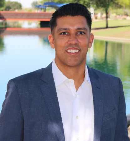 Dr. Puneet Sandhu smiling in a professional outdoor portrait