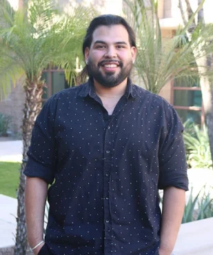 Aaron T. smiling in a professional outdoor portrait