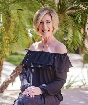 Lilly S. smiling in a professional outdoor portrait