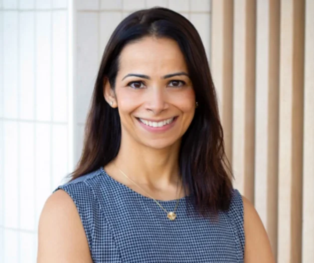 Smiling Dr. Sugandha Mohan in a dental office