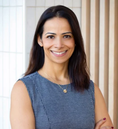 Smiling Dr. Sugandha Mohan in a dental office